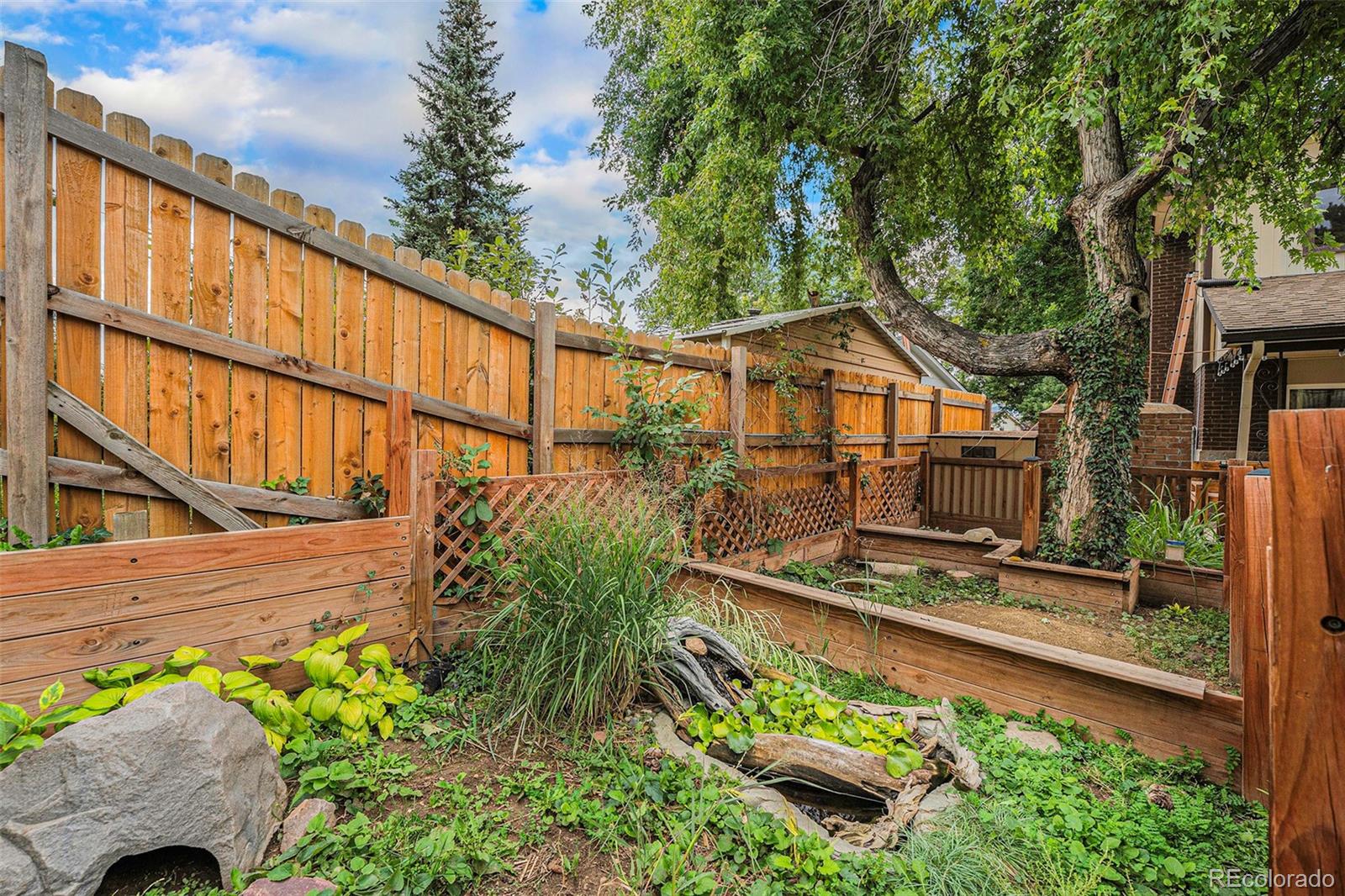2872 South Gray Way Denver, CO 80227 - Photo 29 of 35 a view of a house with wooden fence next to a yard