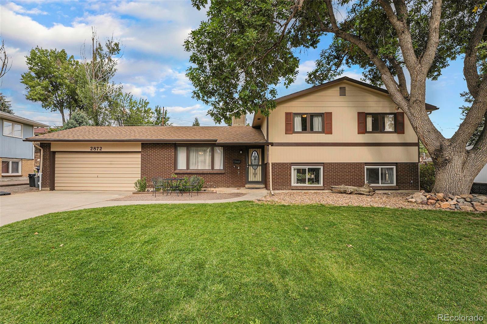2872 South Gray Way Denver, CO 80227 - Photo 3 of 35 a front view of a house with a yard