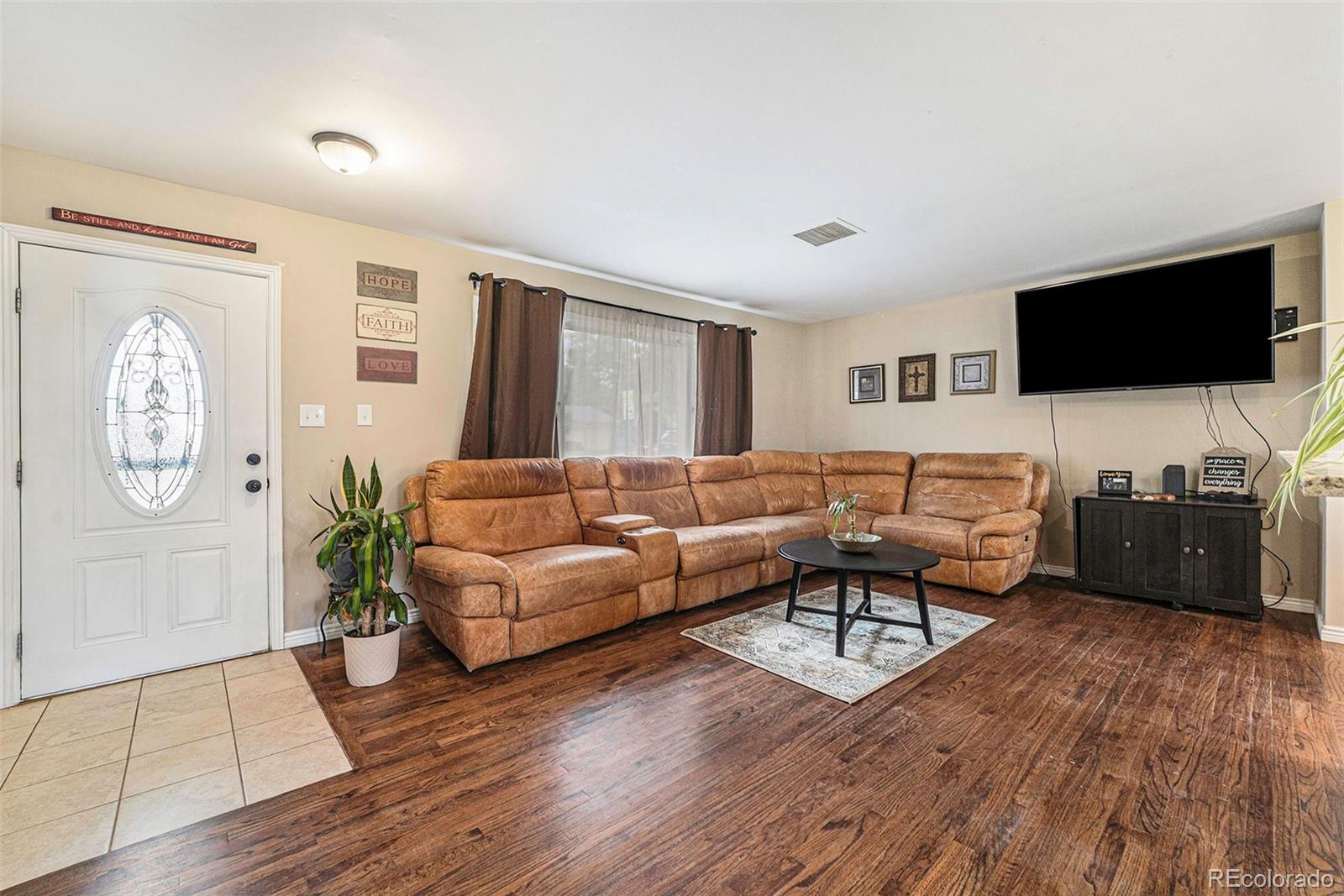 2872 South Gray Way Denver, CO 80227 - Photo 4 of 35 a living room with furniture and a flat screen tv