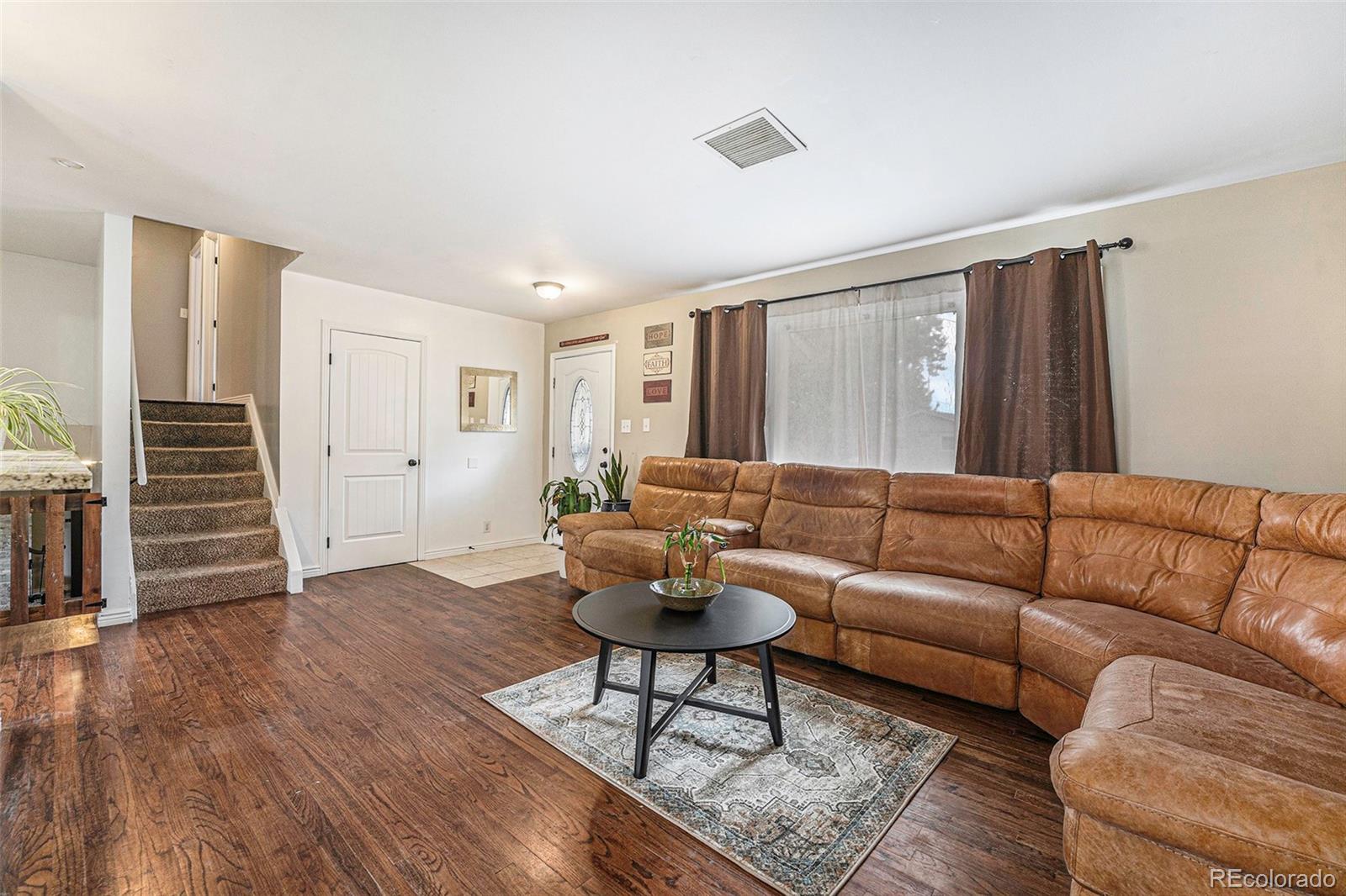 2872 South Gray Way Denver, CO 80227 - Photo 6 of 35 a living room with furniture and a wooden floor