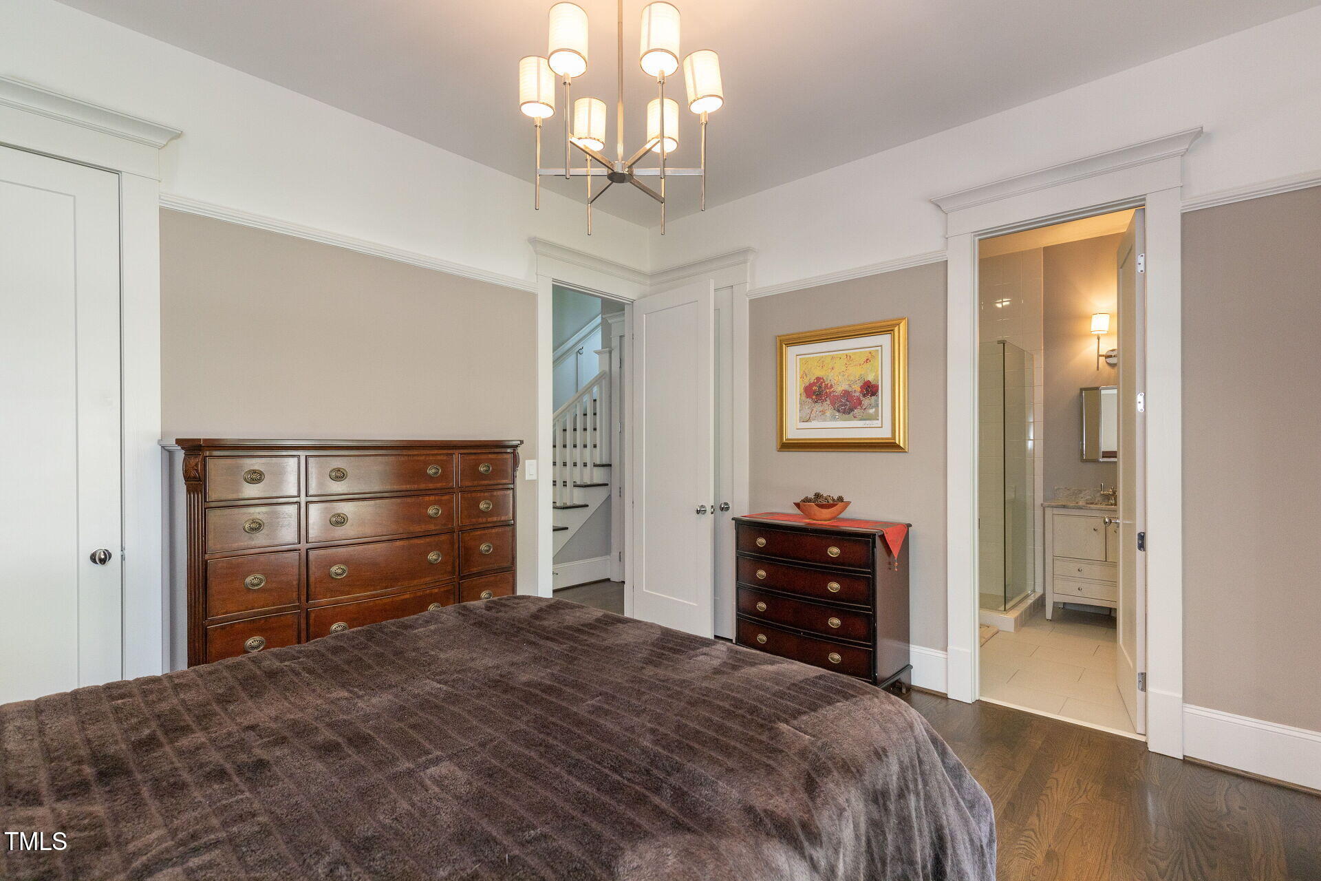 235 Parker Road Chapel Hill, NC 27517 - Photo 18 of 63 a bedroom with a bed and a chandelier