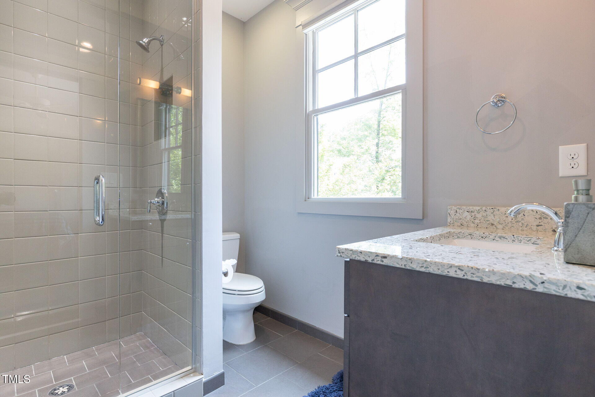235 Parker Road Chapel Hill, NC 27517 - Photo 38 of 63 a bathroom with a granite countertop sink a toilet and shower
