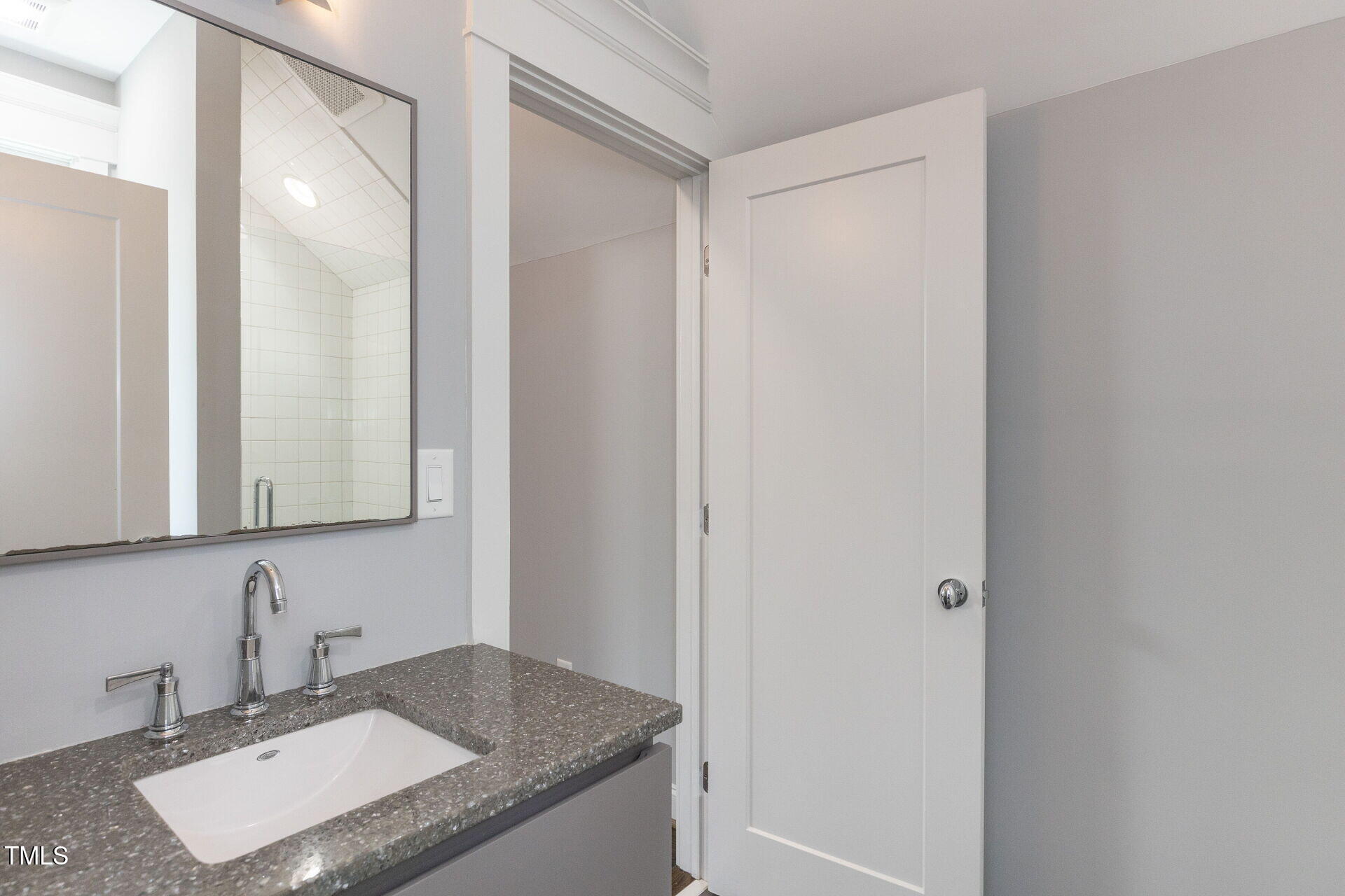 235 Parker Road Chapel Hill, NC 27517 - Photo 49 of 63 a bathroom with a granite countertop sink and a mirror