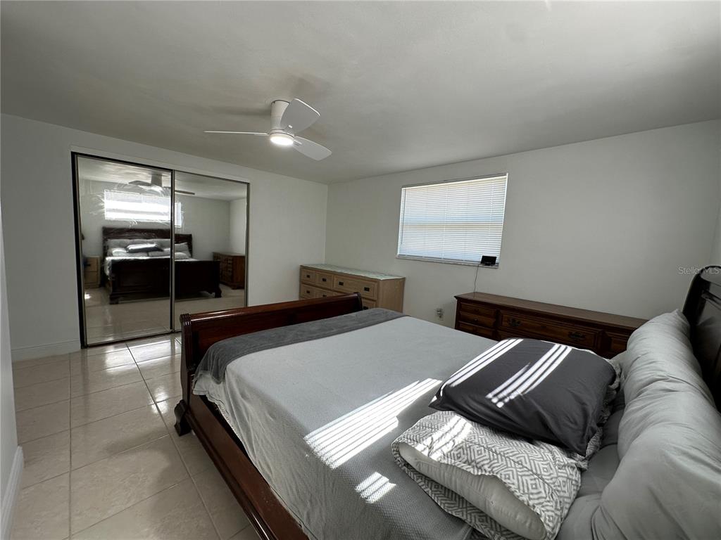 12613 4th Isle Hudson, FL 34667 - Photo 17 of 42 a bed room with a bed and furniture