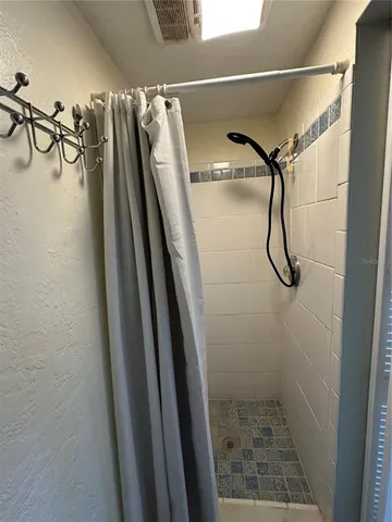 a white toilet sitting next to a bathroom sink and a toilet