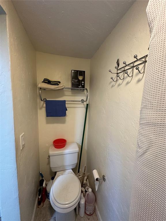 12613 4th Isle Hudson, FL 34667 - Photo 24 of 42 a white toilet sitting next to a bathroom sink and a toilet