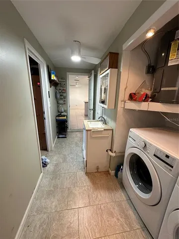 a kitchen with stainless steel appliances granite countertop a sink dishwasher stove top oven a dining table and chairs with wooden floor