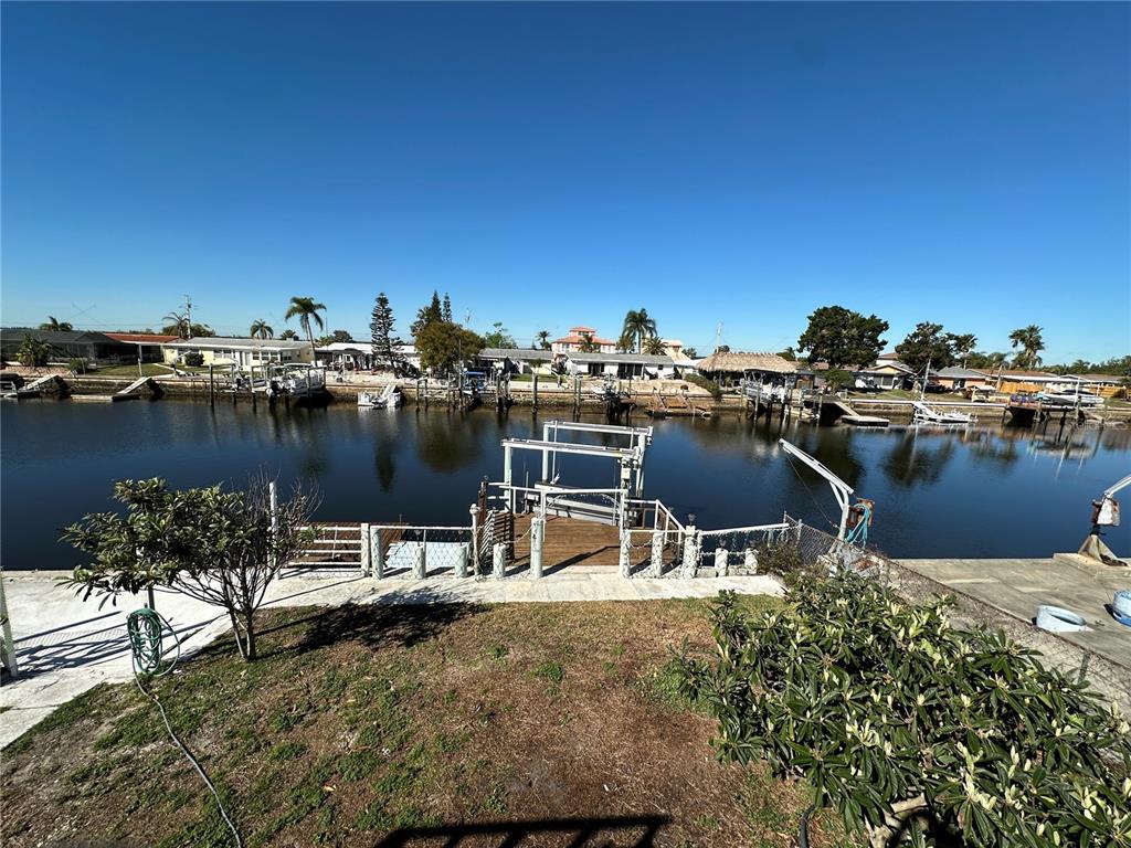 12613 4th Isle Hudson, FL 34667 - Photo 33 of 42 a view of a lake with outdoor space