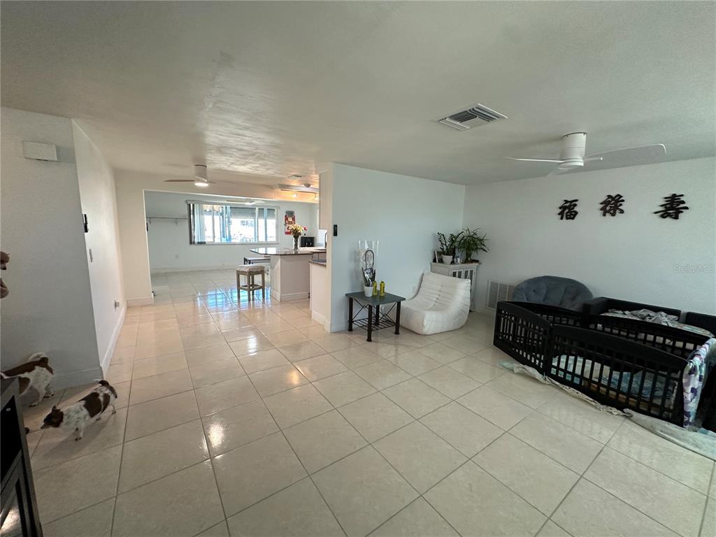 12613 4th Isle Hudson, FL 34667 - Photo 6 of 42 a living room with furniture a dining table and chairs with the kitchen view
