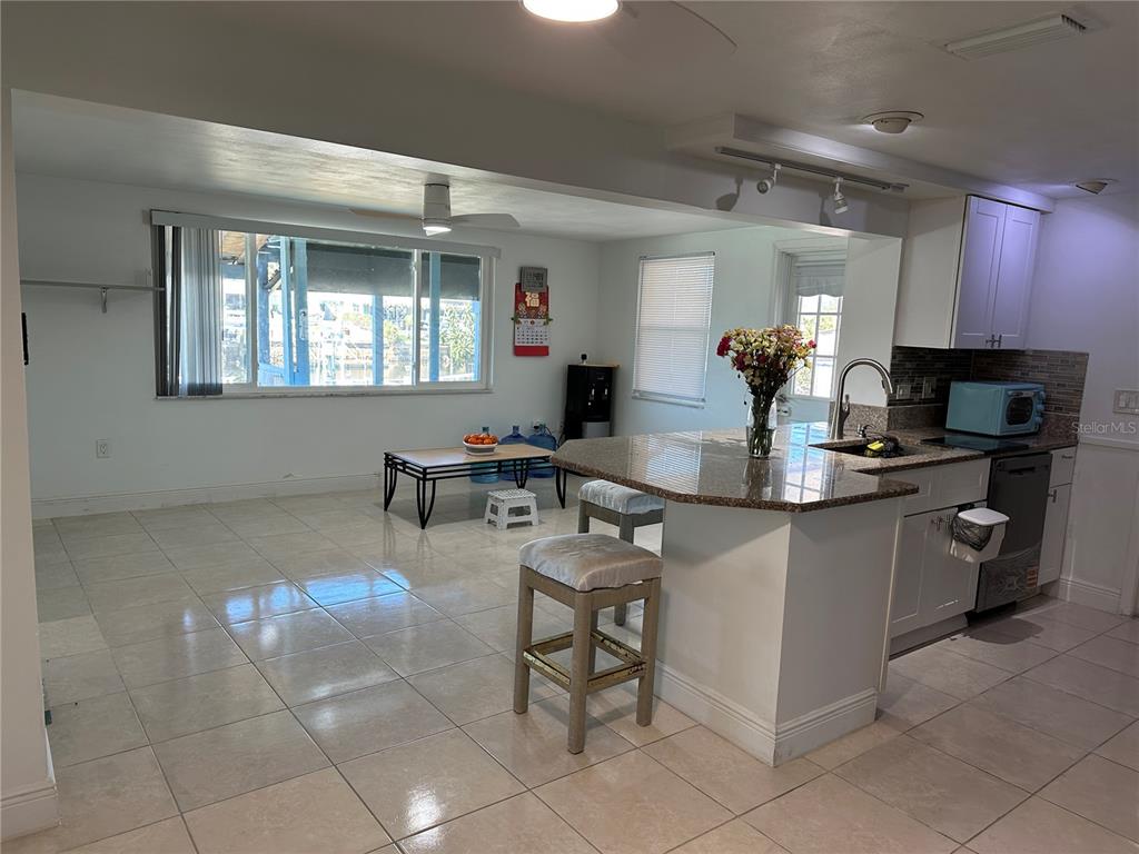 12613 4th Isle Hudson, FL 34667 - Photo 8 of 42 a kitchen with a sink a table and chairs