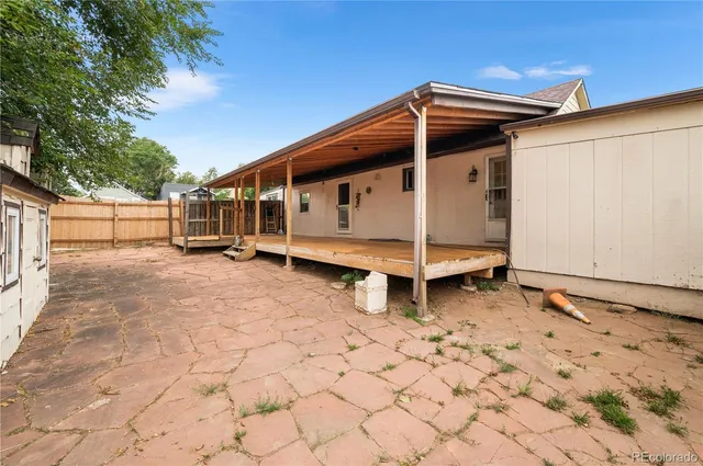 a view of a house with a wooden fence