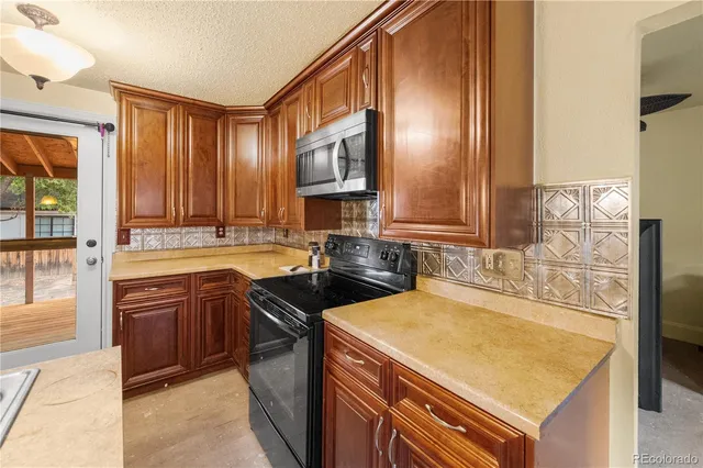 a kitchen with a sink stove and cabinets