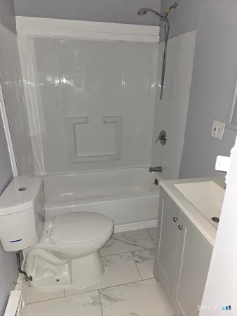 a bathroom with a bathtub toilet and sink