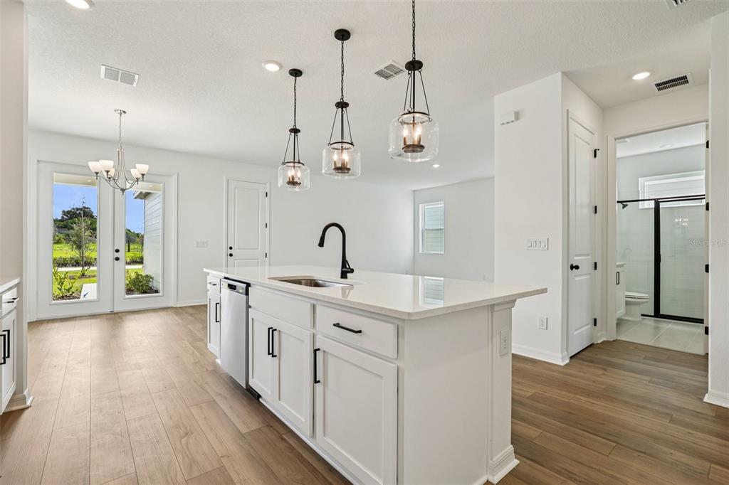 2491 Zuni Road St. Cloud, FL 34771 - Photo 14 of 42 a kitchen with a sink stove and wooden floor