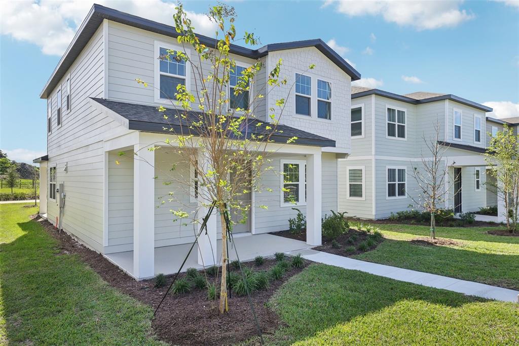 2491 Zuni Road St. Cloud, FL 34771 - Photo 2 of 42 a front view of a house with a yard