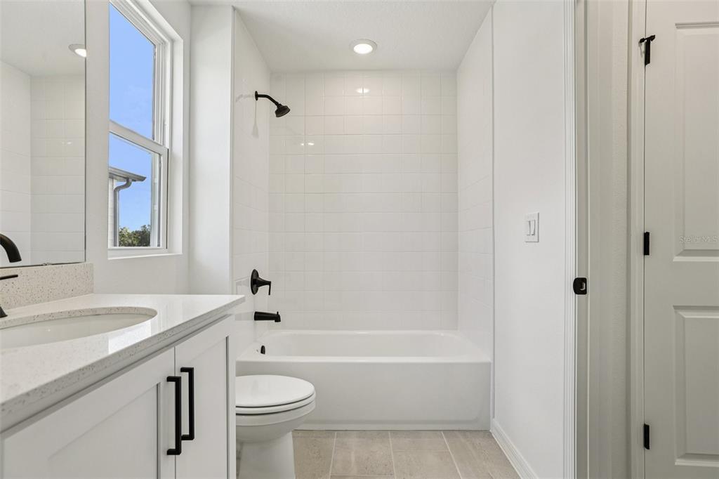 2491 Zuni Road St. Cloud, FL 34771 - Photo 29 of 42 a bathroom with a sink a toilet and shower