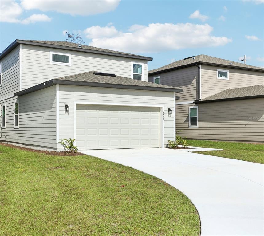 2491 Zuni Road St. Cloud, FL 34771 - Photo 40 of 42 a front view of a house with a garage