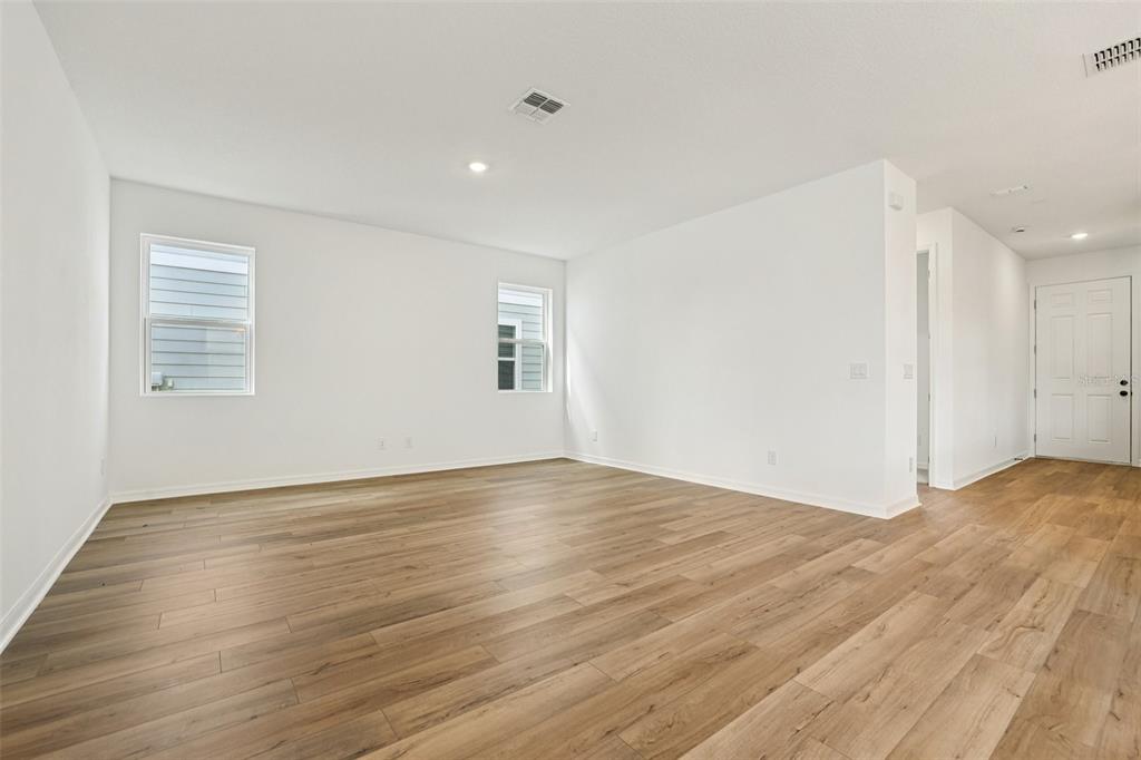 2491 Zuni Road St. Cloud, FL 34771 - Photo 4 of 42 a view of an empty room with wooden floor and a window