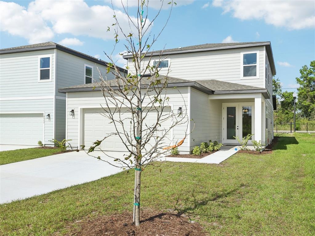 2491 Zuni Road St. Cloud, FL 34771 - Photo 41 of 42 a front view of a house with garden