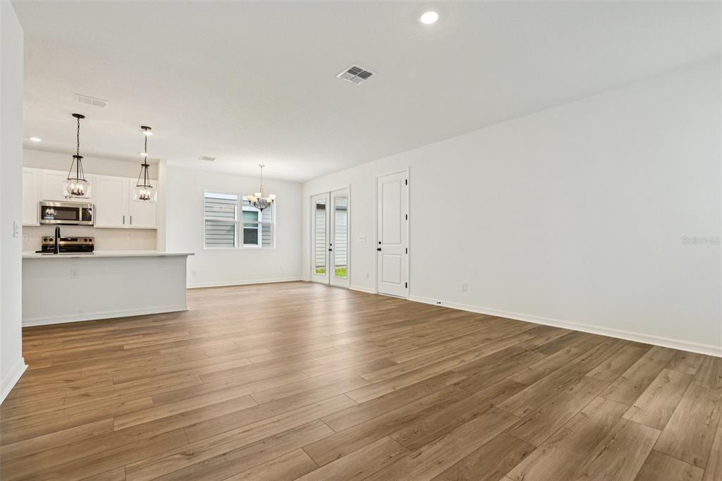 2491 Zuni Road St. Cloud, FL 34771 - Photo 6 of 42 a view of a kitchen with wooden floor and a kitchen