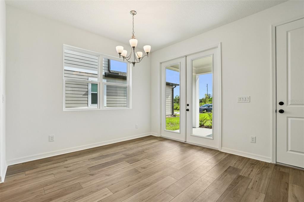 2491 Zuni Road St. Cloud, FL 34771 - Photo 9 of 42 a view of an empty room with a window and wooden floor