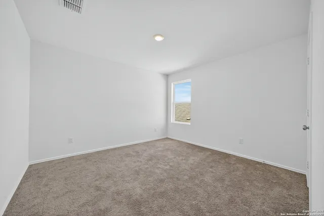a view of an empty room and a window