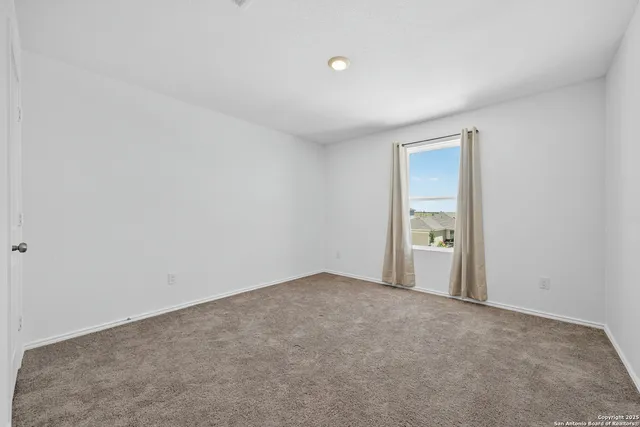 a view of an empty room and a window