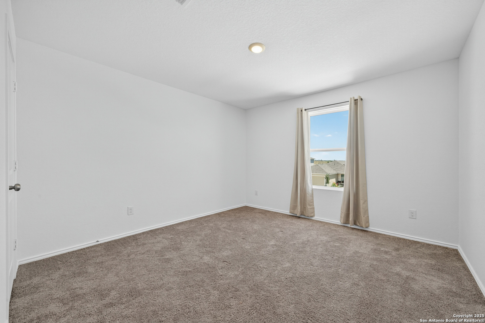 10716 Sweepback Trail Converse, TX 78109 - Photo 19 of 26 a view of an empty room and a window