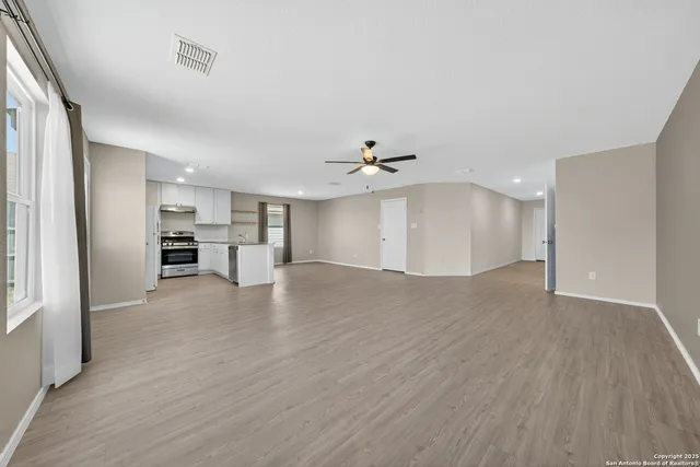 a view of a kitchen with wooden floor and a kitchen