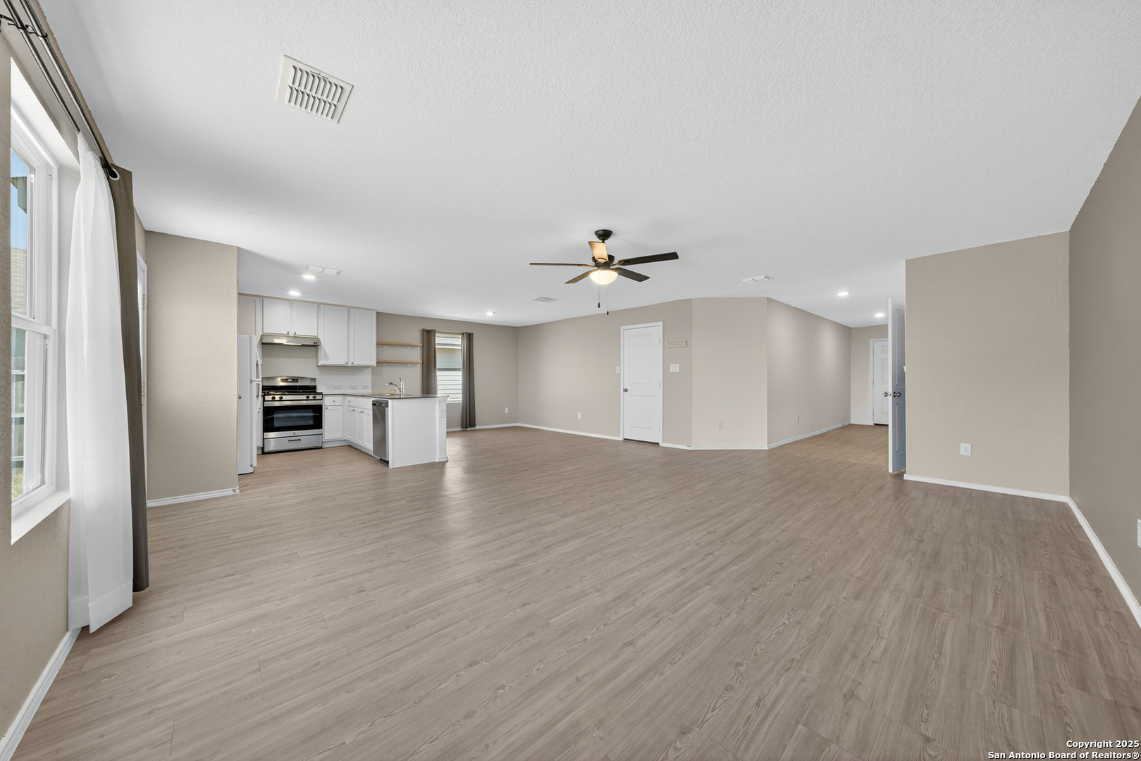 10716 Sweepback Trail Converse, TX 78109 - Photo 7 of 26 a view of a kitchen with wooden floor and a kitchen