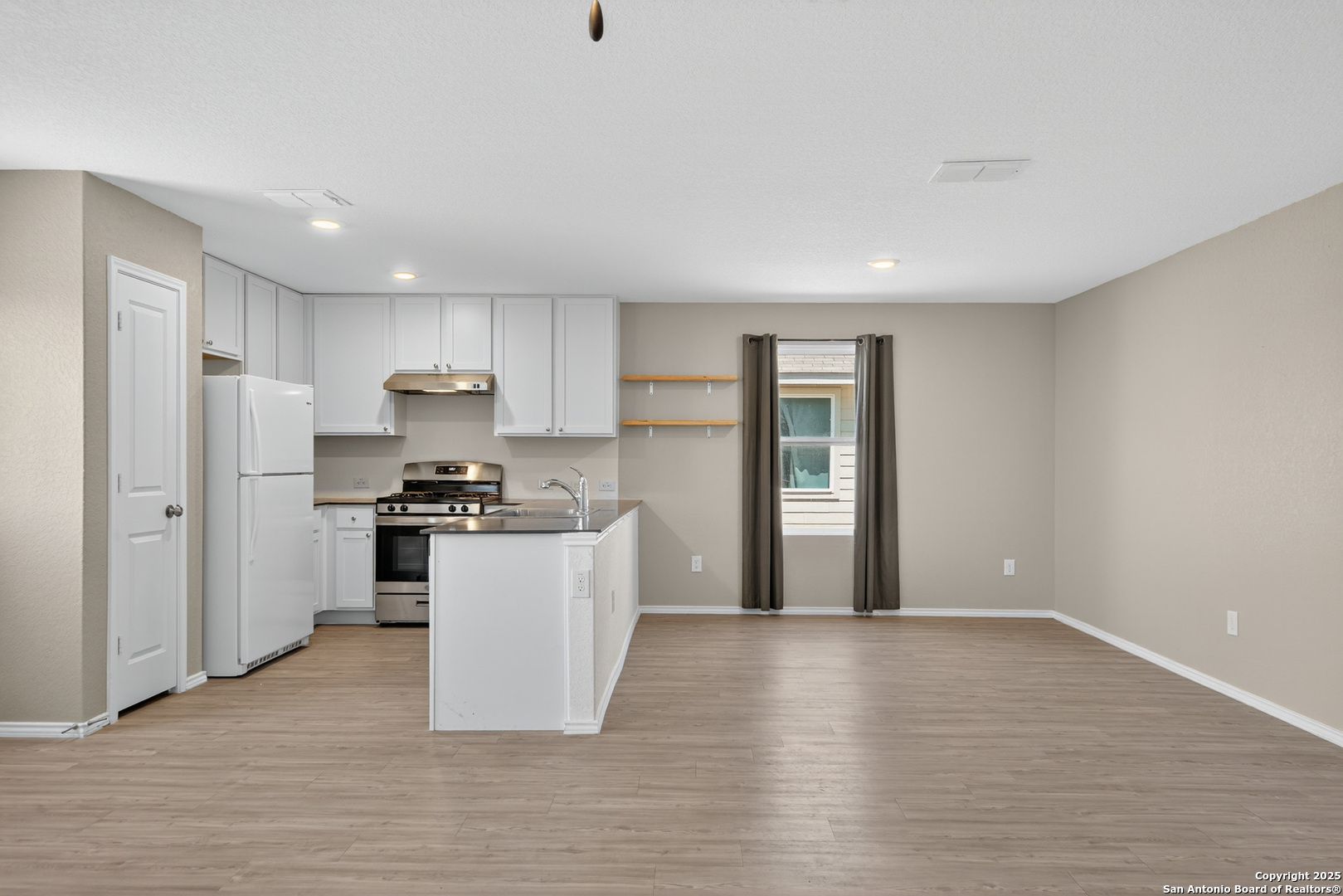 10716 Sweepback Trail Converse, TX 78109 - Photo 8 of 26 a kitchen with stainless steel appliances granite countertop a refrigerator sink and stove
