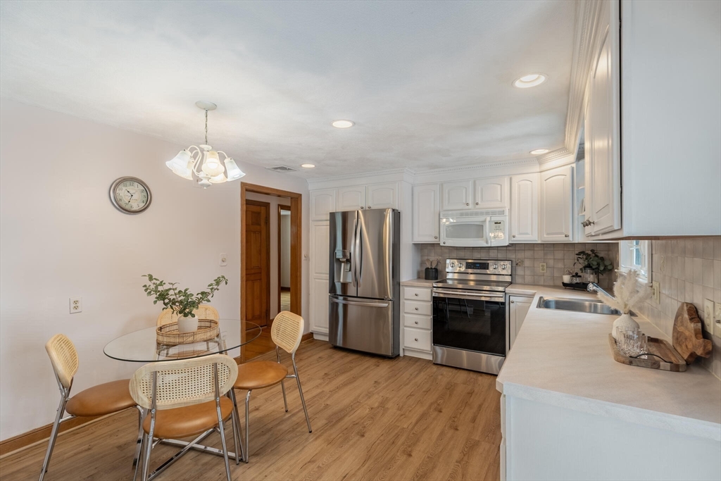 2 Rodgers Road Stoneham, MA 02180 - Photo 11 of 38 a kitchen with refrigerator a sink and chairs