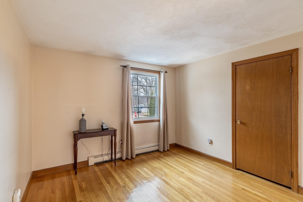 2 Rodgers Road Stoneham, MA 02180 - Photo 16 of 38 a view of a livingroom with wooden floor and a window