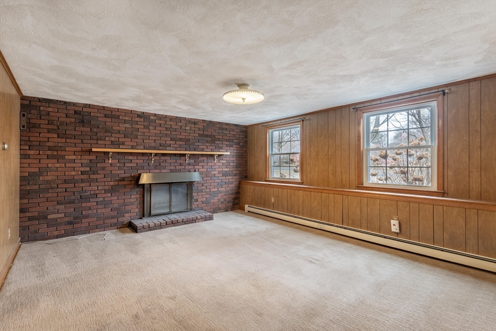 2 Rodgers Road Stoneham, MA 02180 - Photo 22 of 38 an empty room with windows and fireplace