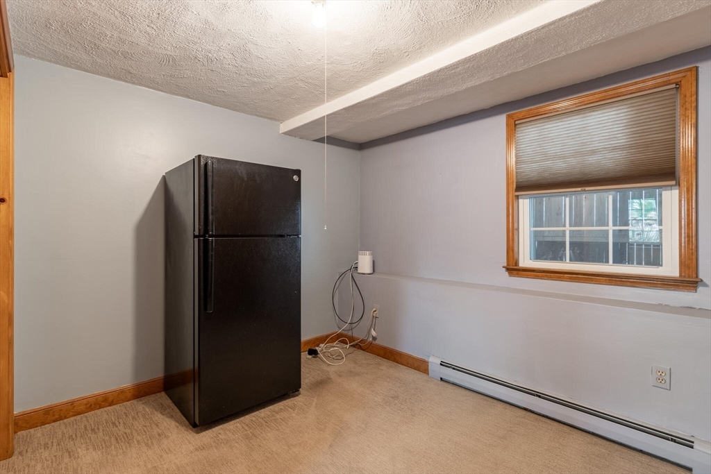 2 Rodgers Road Stoneham, MA 02180 - Photo 24 of 38 a kitchen with a refrigerator and window