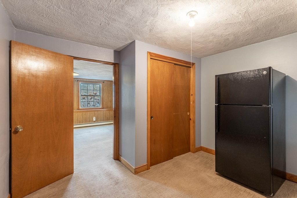 2 Rodgers Road Stoneham, MA 02180 - Photo 25 of 38 a view of a hallway with a refrigerator in kitchen
