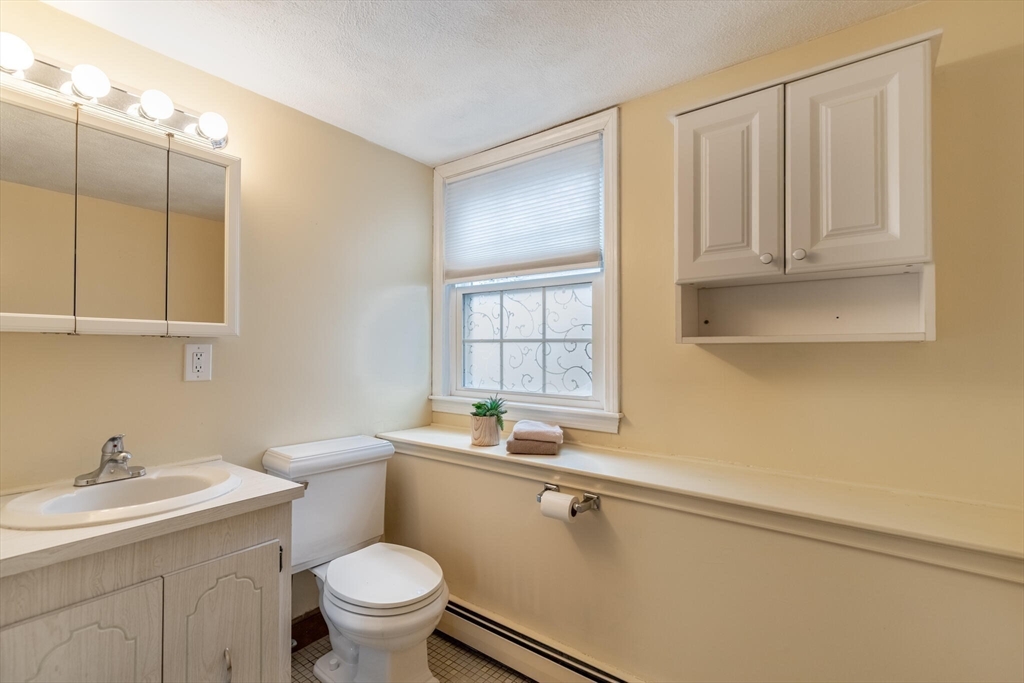 2 Rodgers Road Stoneham, MA 02180 - Photo 26 of 38 a bathroom with a sink a toilet and a mirror