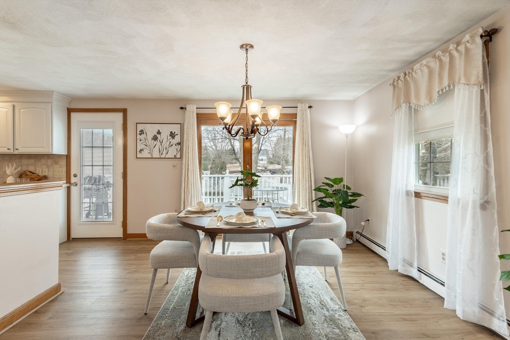 2 Rodgers Road Stoneham, MA 02180 - Photo 9 of 38 a dining room with furniture a chandelier and wooden floor