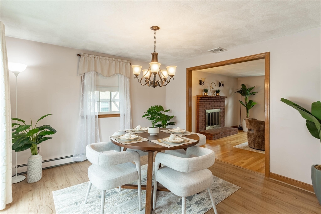 2 Rodgers Road Stoneham, MA 02180 - Photo 10 of 38 a dining room with furniture potted plants and wooden floor