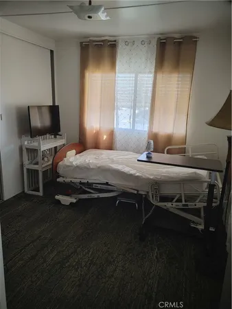 a bedroom with a bed and flat screen tv
