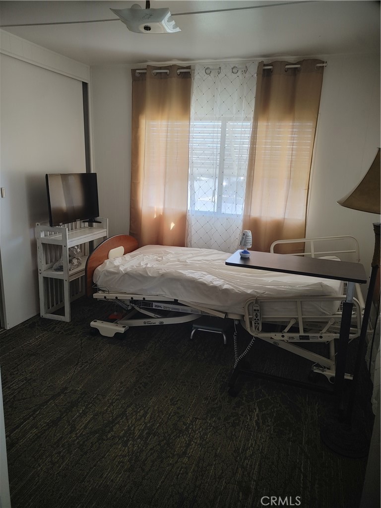 13645 5th Street, Unit 75 Yucaipa, CA 92399 - Photo 11 of 12 a bedroom with a bed and flat screen tv