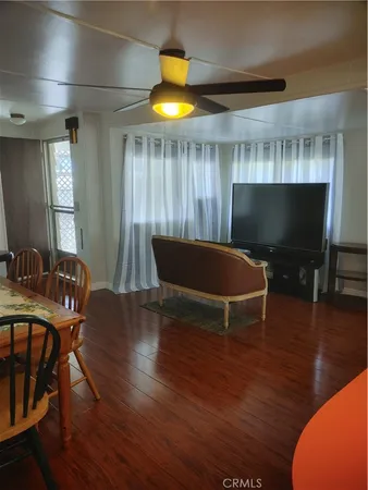 a room with wooden floor and furniture