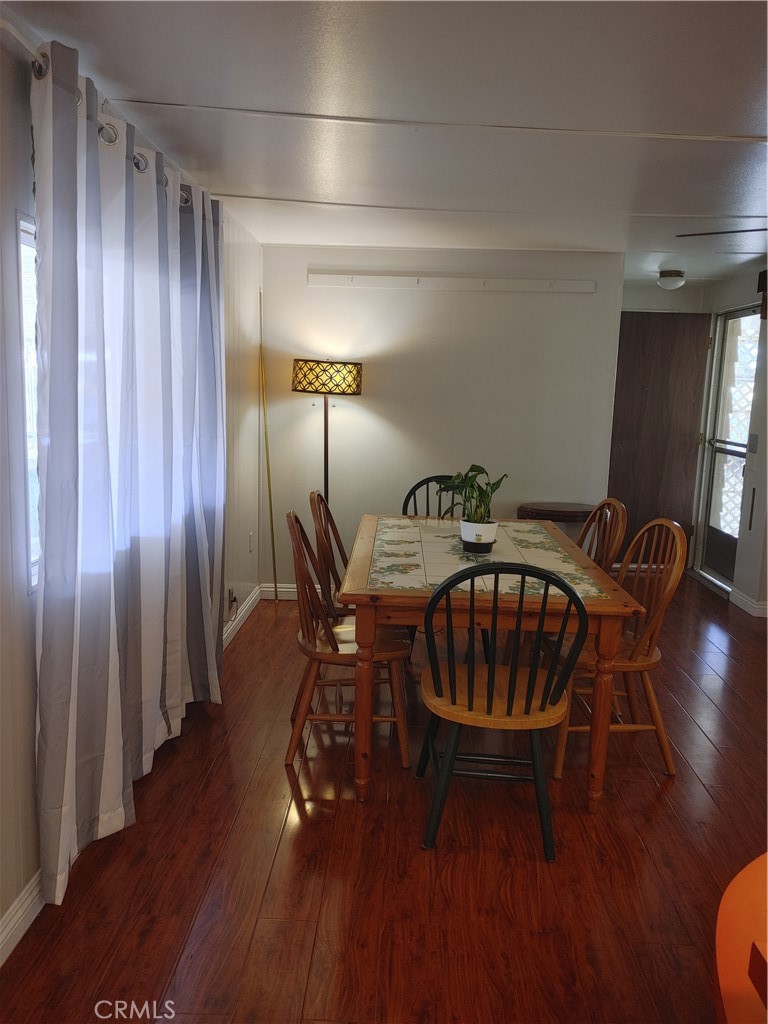 13645 5th Street, Unit 75 Yucaipa, CA 92399 - Photo 6 of 12 a view of a dining room with furniture window and wooden floor