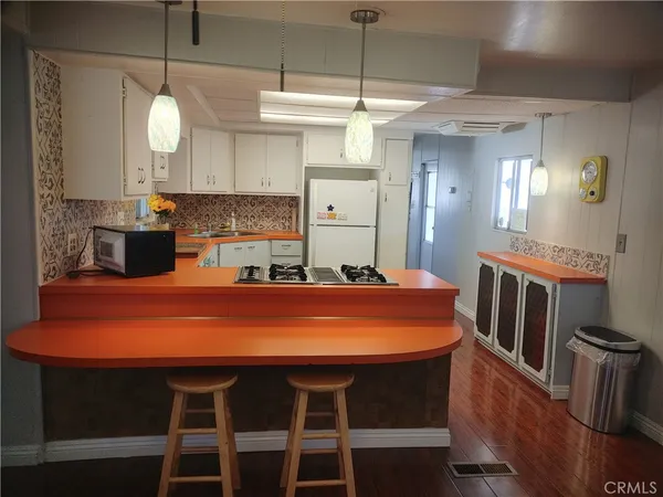 a large kitchen with a table and chairs