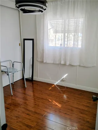 a view of a room with wooden floor and windows