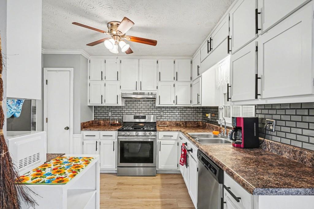 114 Copeland Lane Stockbridge, GA 30281 - Photo 14 of 40 a kitchen with stainless steel appliances granite countertop a stove and a sink