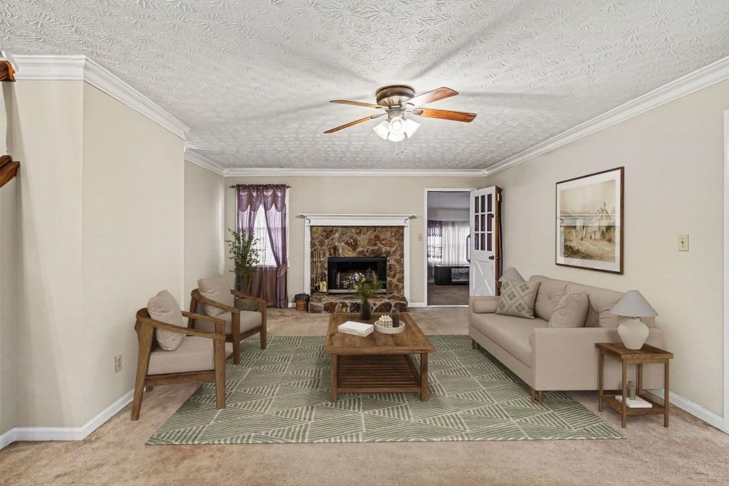 114 Copeland Lane Stockbridge, GA 30281 - Photo 2 of 40 a living room with furniture a fireplace and a flat screen tv