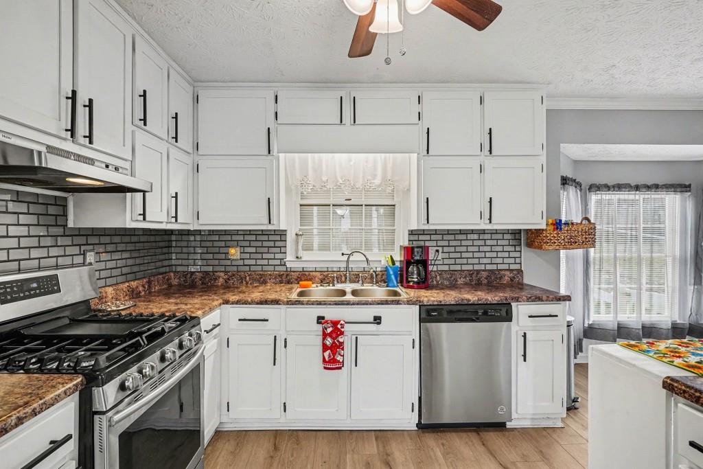 114 Copeland Lane Stockbridge, GA 30281 - Photo 3 of 40 a kitchen with stainless steel appliances granite countertop a stove and a sink