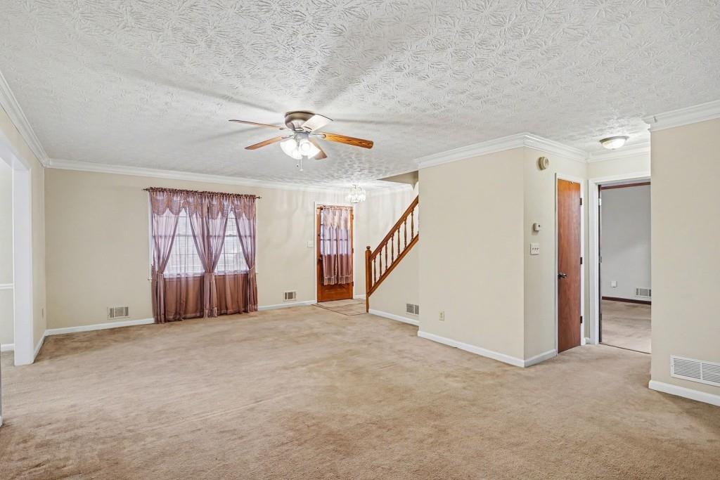 114 Copeland Lane Stockbridge, GA 30281 - Photo 10 of 40 an empty room with windows and chandelier fan