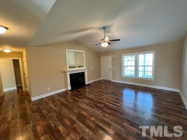 21 Hunters Point Court Angier, NC 27501 - Photo 8 of 39 an empty room with wooden floor fireplace and windows